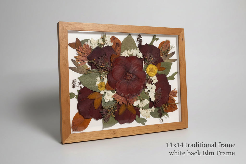 Framed pressed flowers on a light blue surface