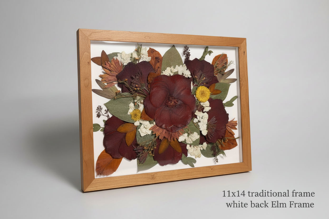 Framed pressed flowers on a light blue surface