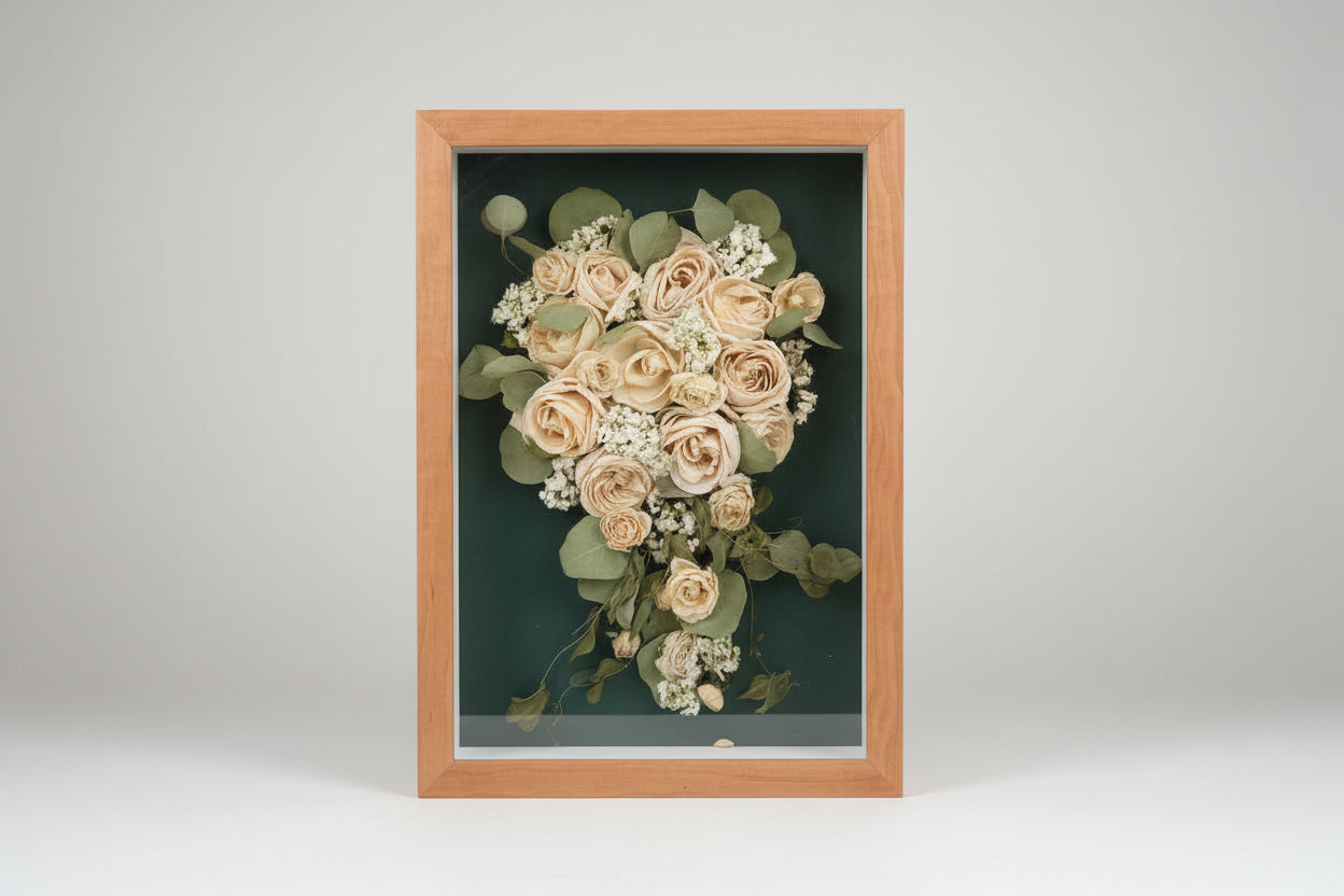 Framed bouquet of White roses and greenery on a dark green background