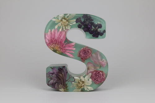 Resin Letter S with colorful flowers inside with a sage green background