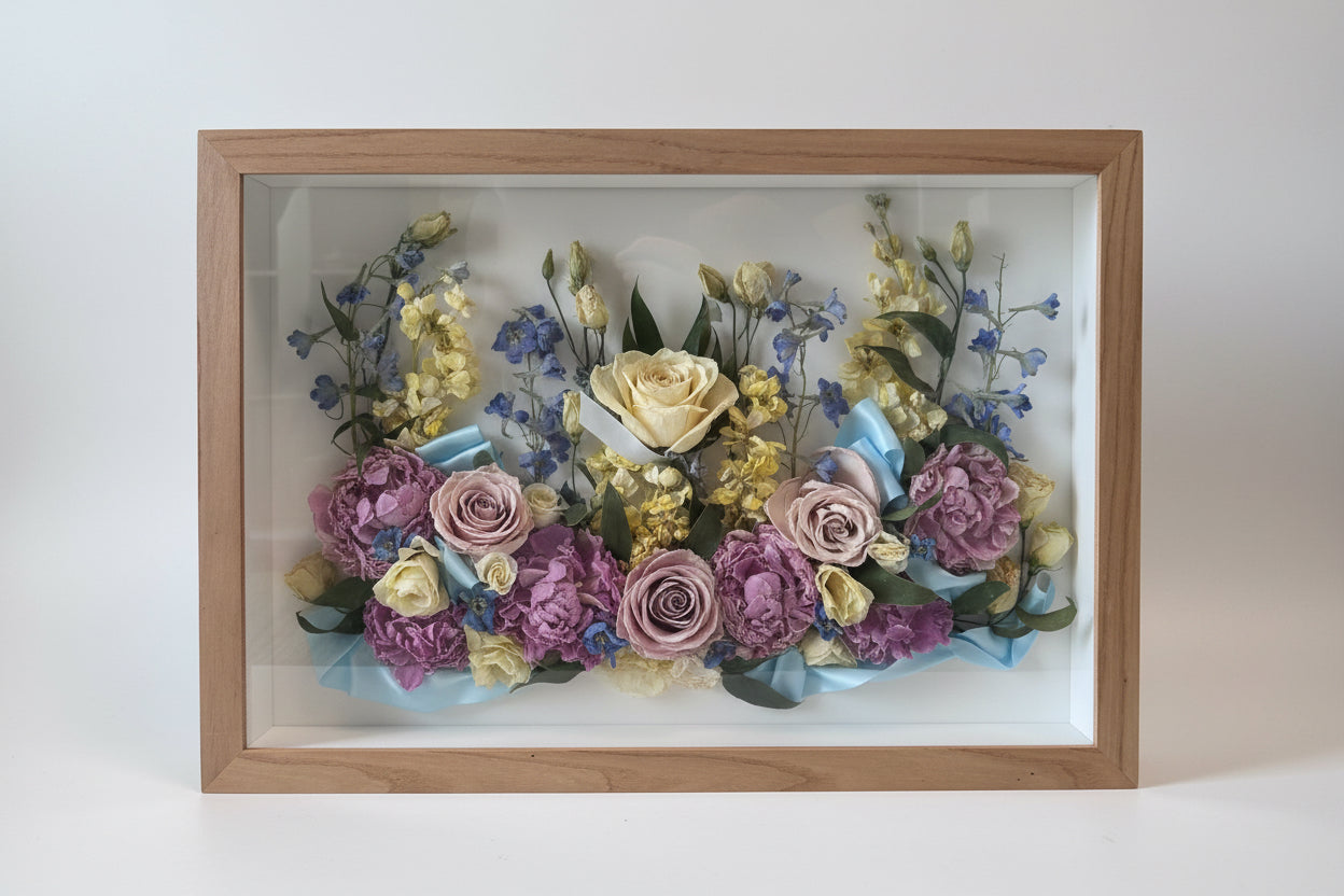 Framed arrangement of dried flowers with a wooden frame