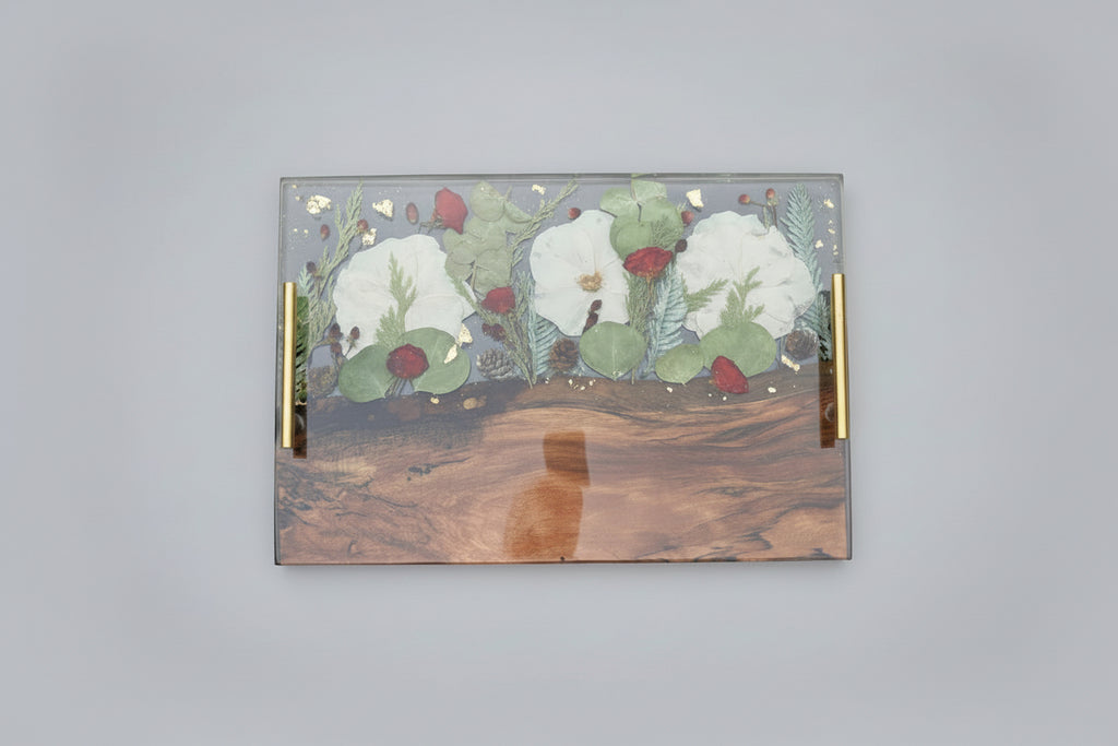 Decorative wooden tray with floral design on a dark background