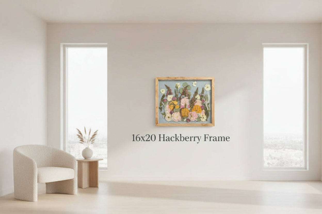 Modern room with a pressed flower frame on the wall, a chair, and a small table.