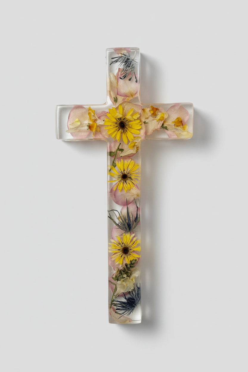 Decorative cross with pressed flowers on a white background