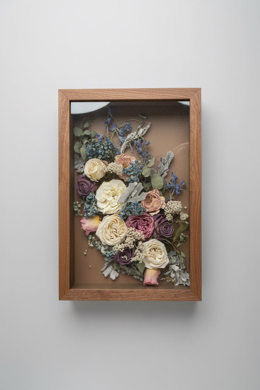 Wooden frame with pressed flowers on a light gray background