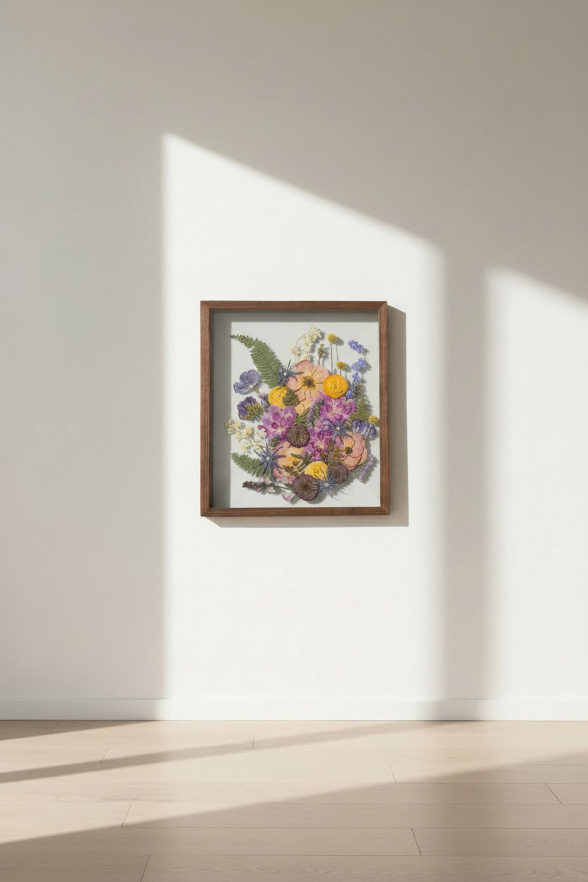 preserved flowers inside dark frame on wall