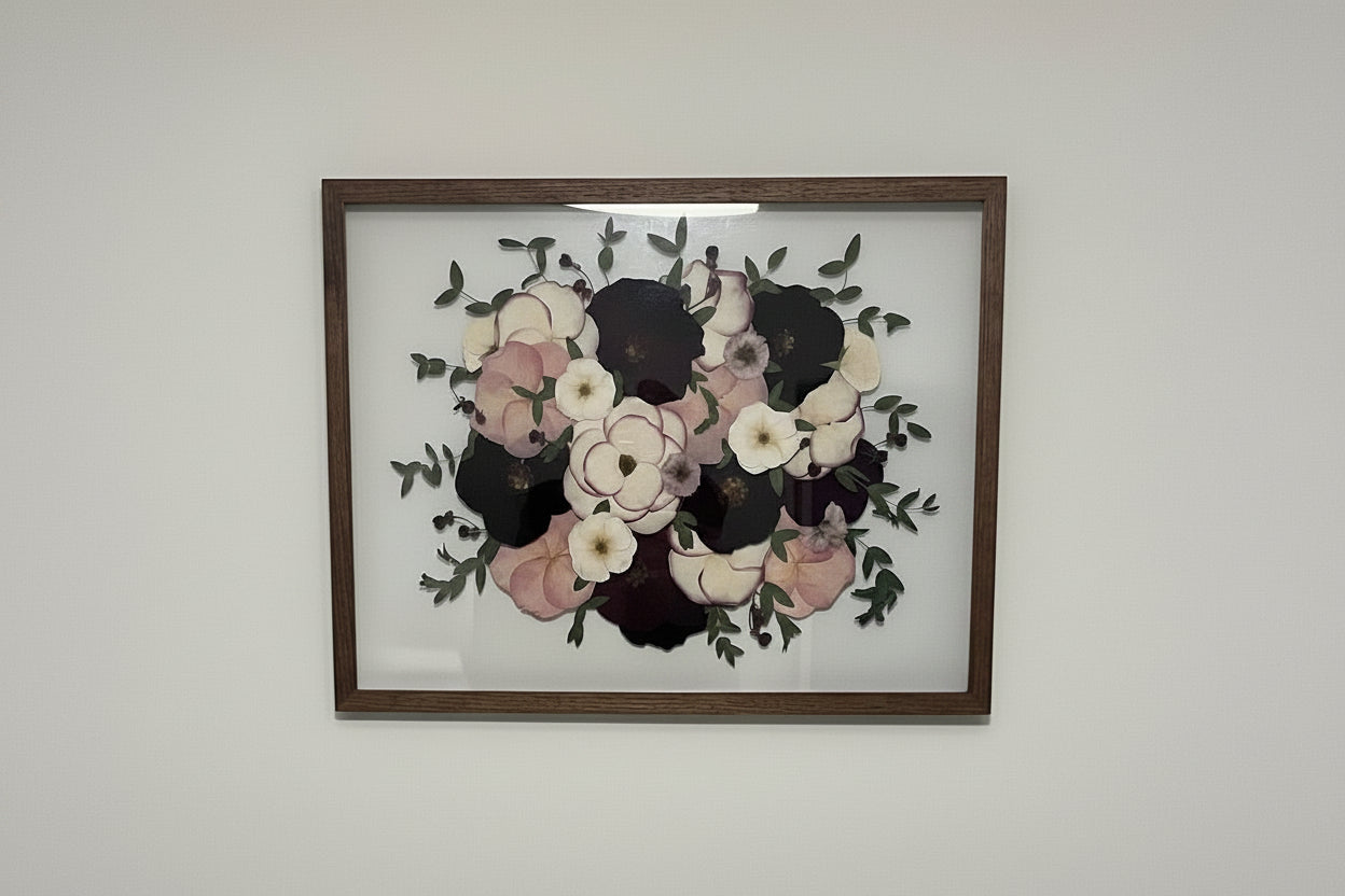 Framed floral artwork on a plain wall