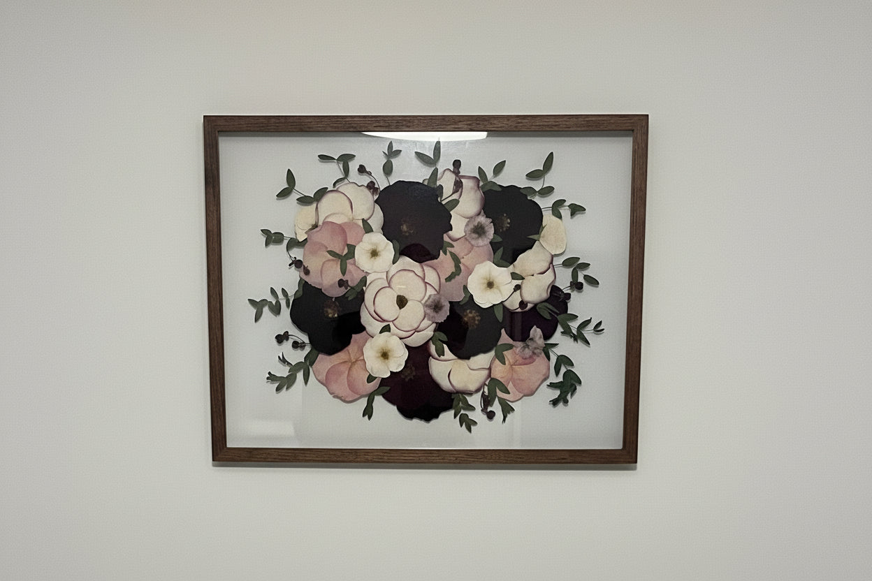 Framed floral artwork on a plain wall