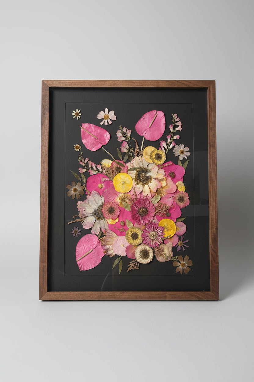 Framed pressed flower arrangement on a table