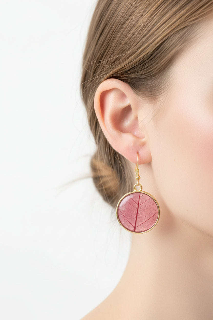 Red Leaf earrings with gold bezel on womans ear