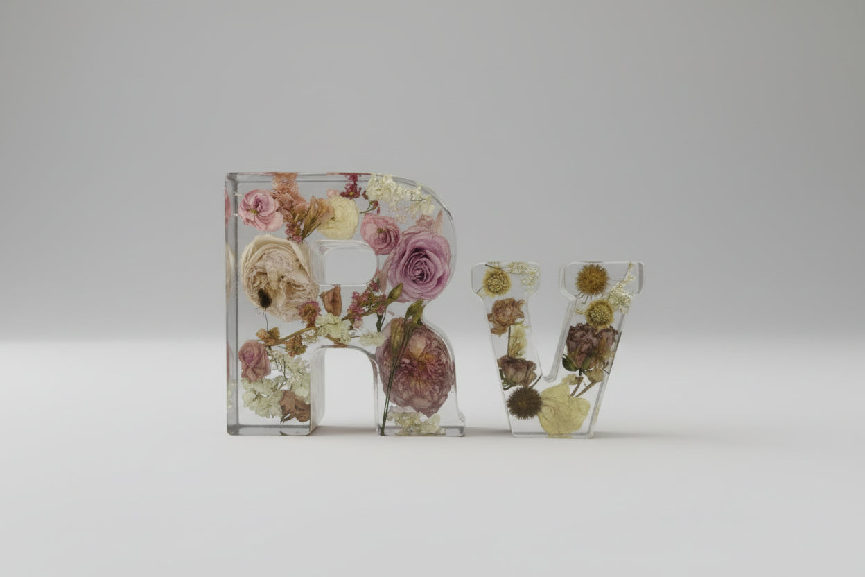 Decorative letters 'R' and 'W' filled with pressed flowers on a white background