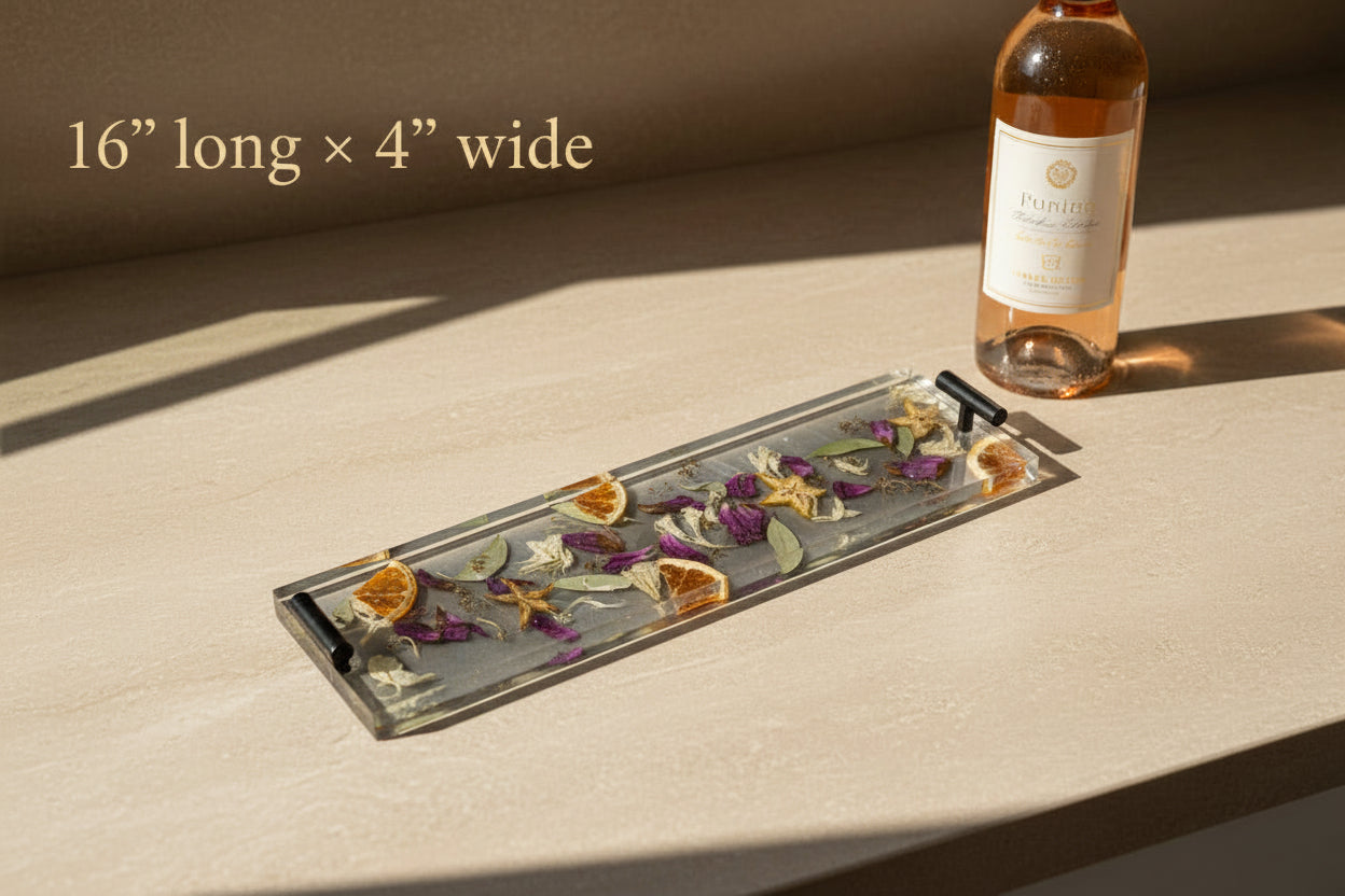 Decorative tray with pressed flowers and citrus slices on a wooden surface