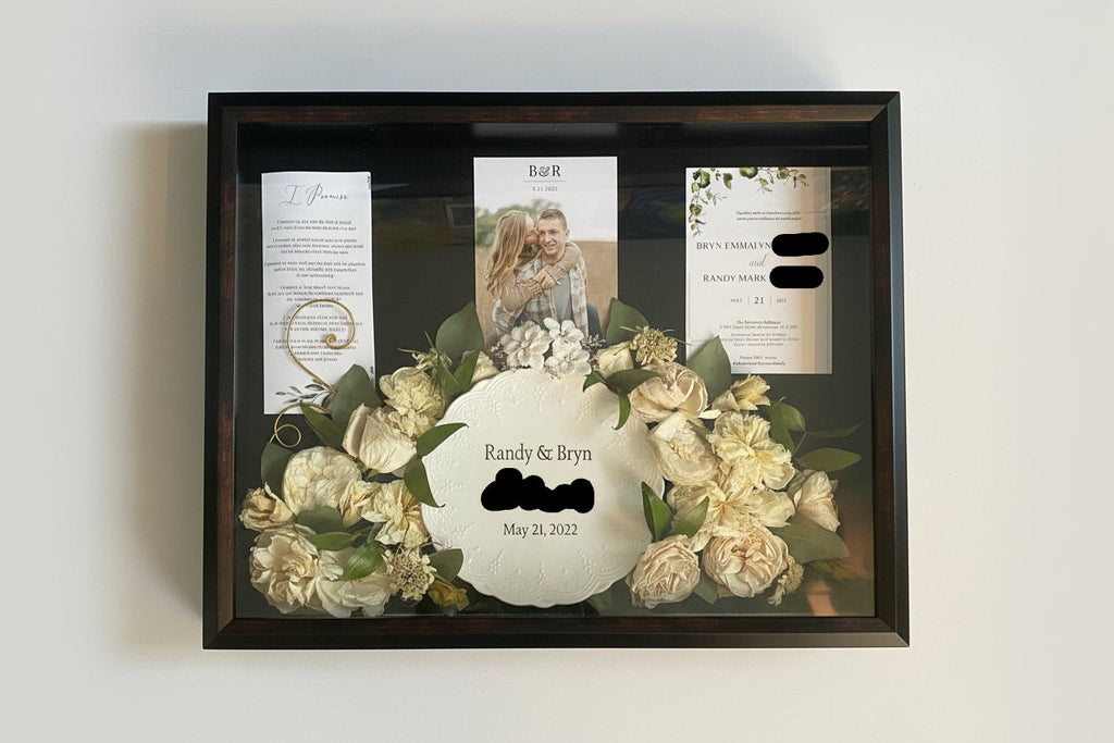 Framed wedding shadow box with flowers and personalized text on a white background