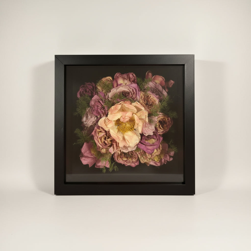 Framed floral arrangement on a white background