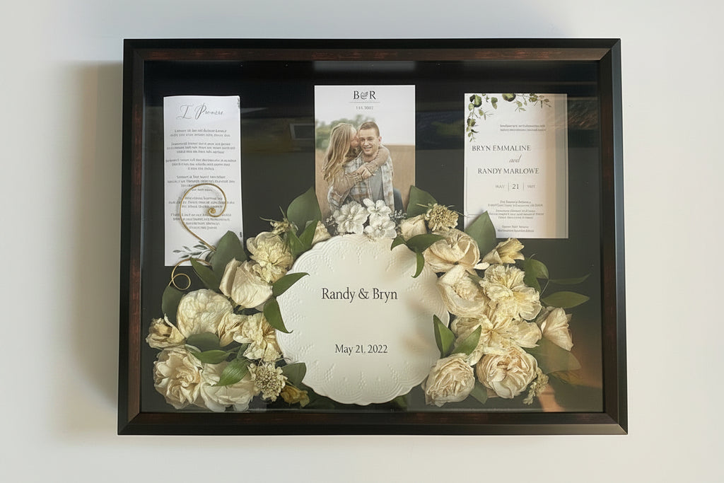 Framed wedding shadow box with flowers and personalized text on a white background