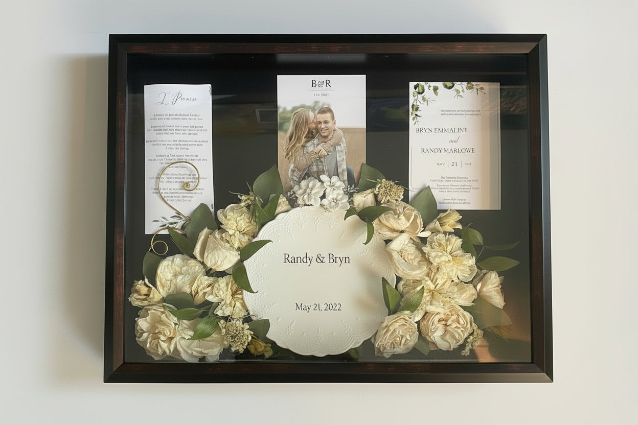 Framed wedding shadow box with flowers and personalized text on a white background