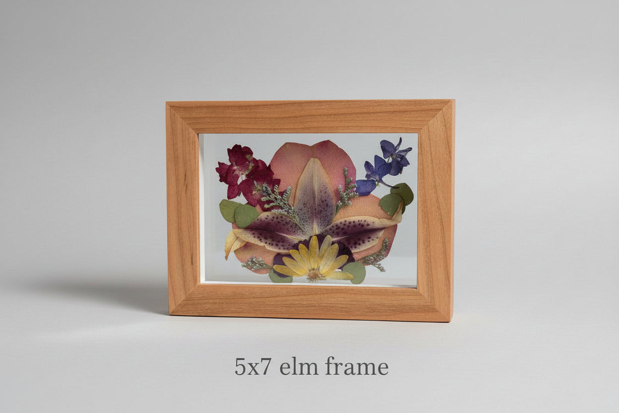 Framed artwork with pressed flowers on a gray background