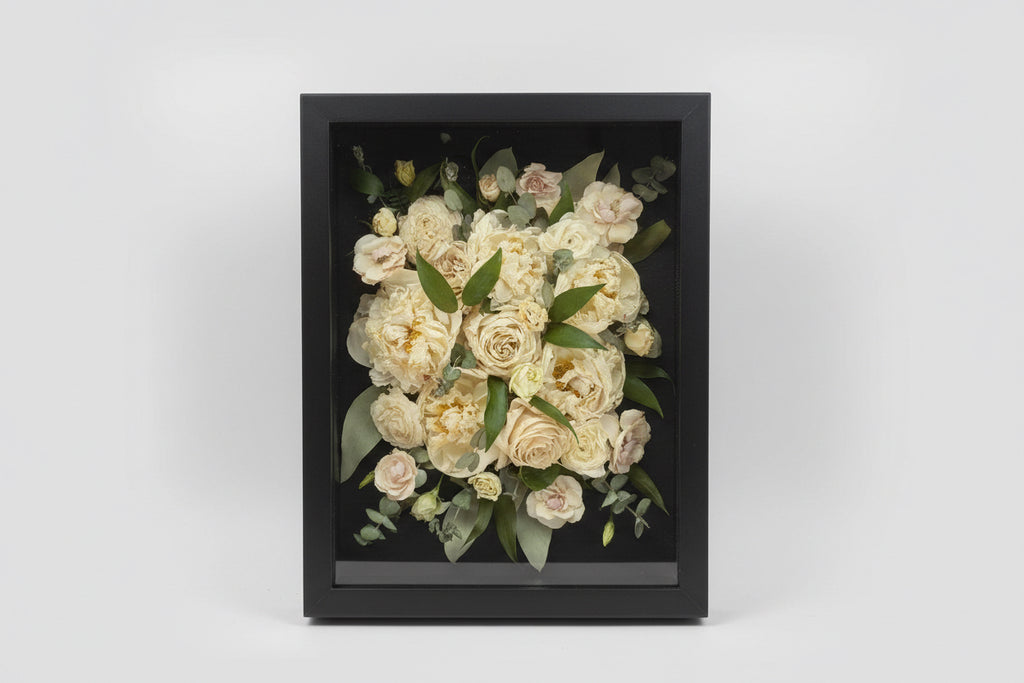 Framed bouquet of flowers with a dark frame