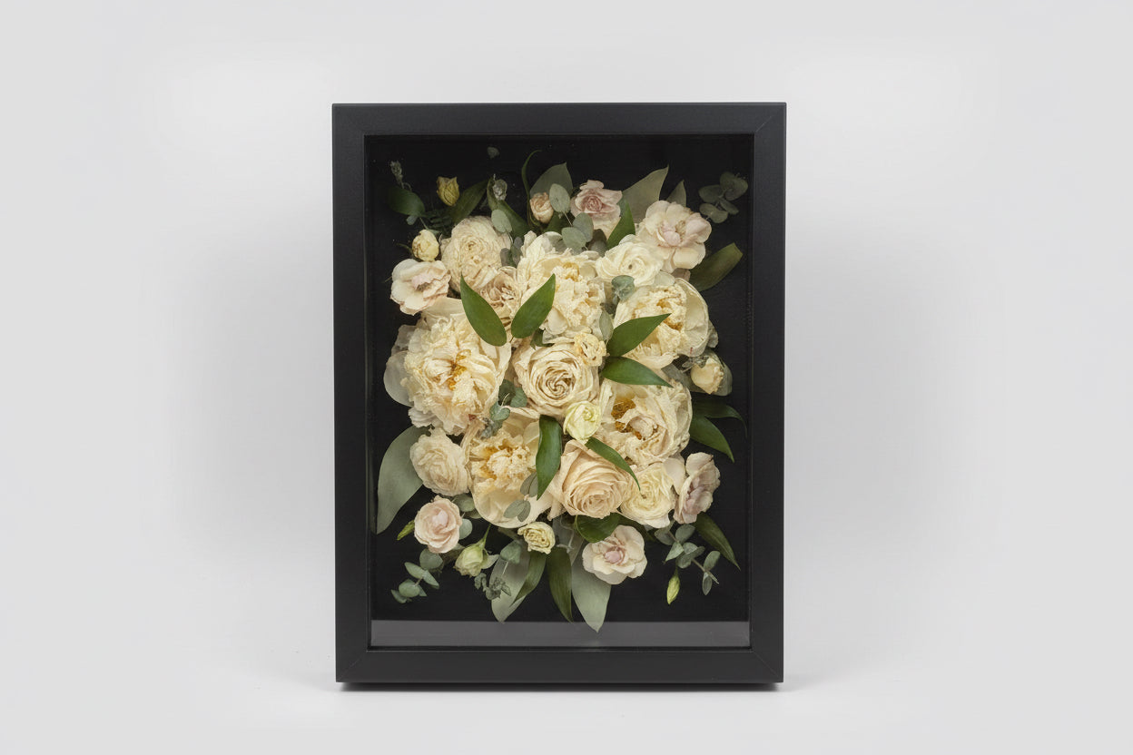 Framed bouquet of flowers with a dark frame