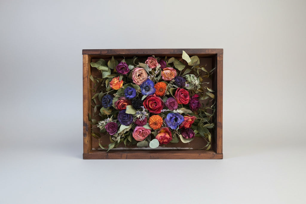 Colorful bouquet of flowers in a wooden box