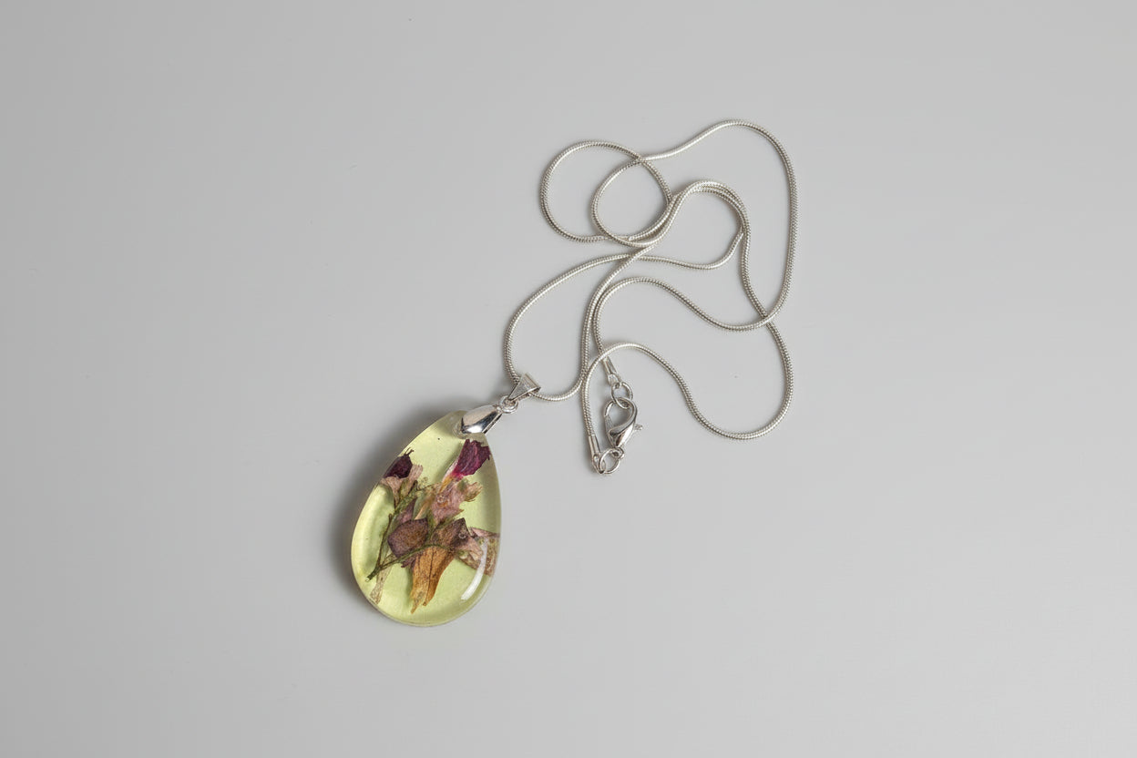 Necklace with a pendant featuring floral design on a gray background